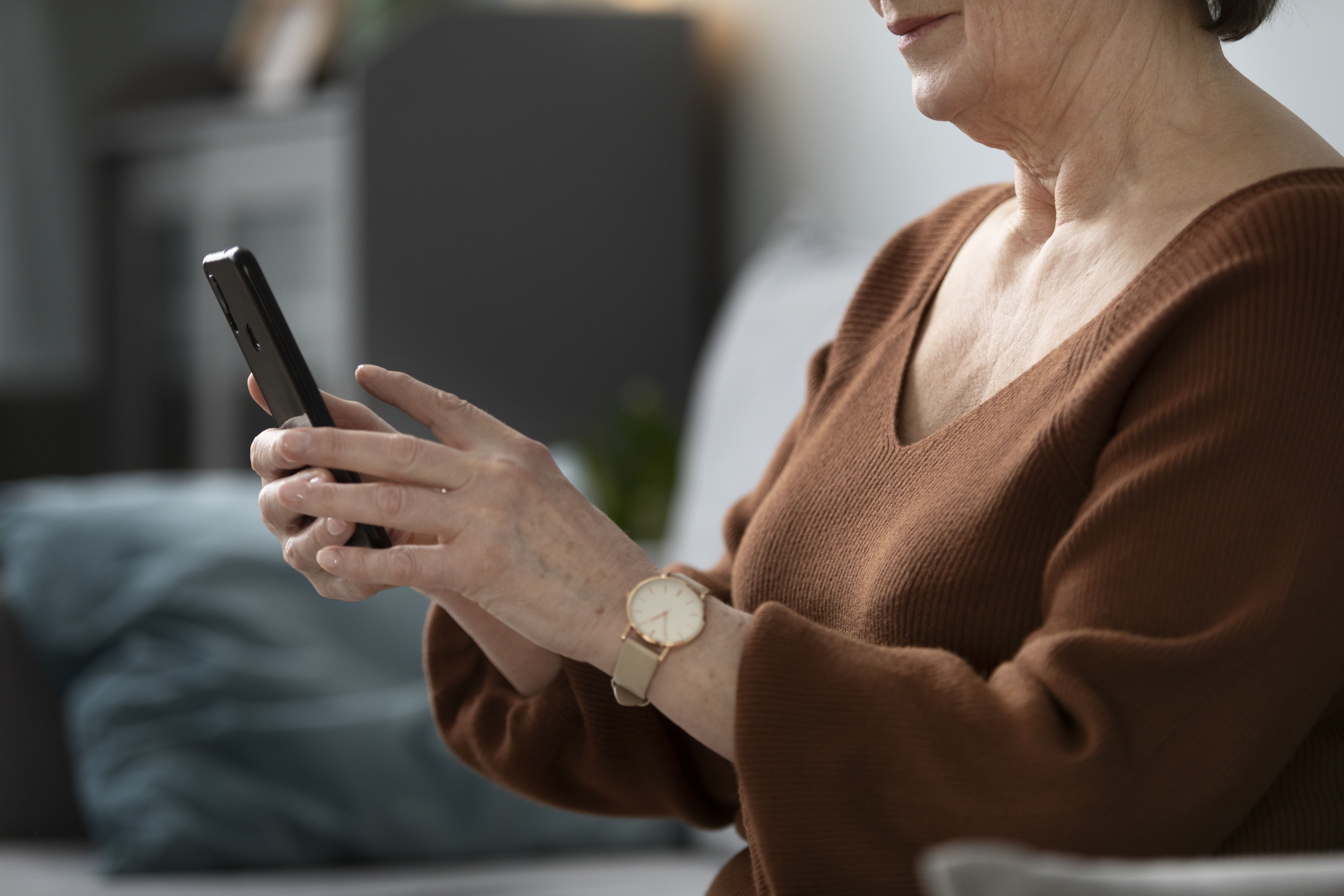 happy-senior-woman-using-smartphone-living-room-modern-apartment (2) (1).jpg